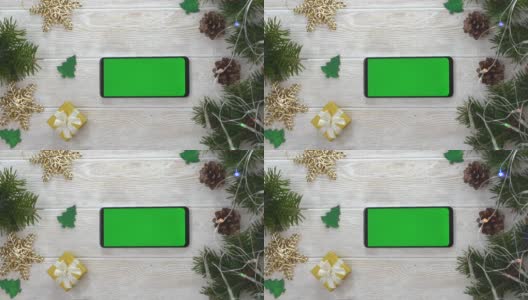 绿屏技术手机在圣诞装饰桌上俯视图平放，模拟空间为复制文字，智能手机色度键，新年在线概念无人高清在线视频素材下载