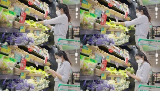 亚洲女孩戴着口罩保护她的脸在超市购物高清在线视频素材下载