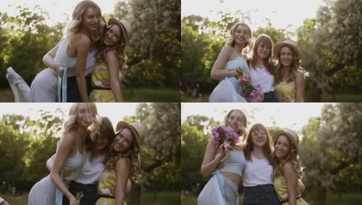 三个漂亮的女人在镜头前摆姿势。拥抱,微笑着。未婚女子的概念。女孩们在绿色的公园里一起玩高清在线视频素材下载