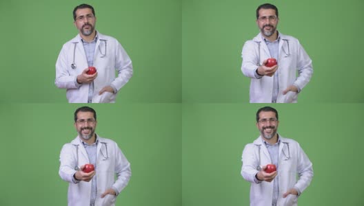 英俊的波斯胡子男子医生作为营养学家给苹果高清在线视频素材下载