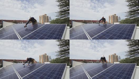 太阳能技术员在屋顶上安装太阳能电池板。高清在线视频素材下载