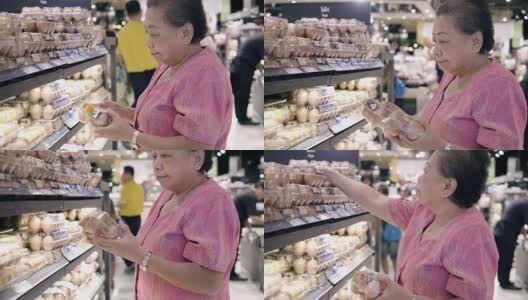 亚洲资深人士在超市挑选鸡蛋高清在线视频素材下载