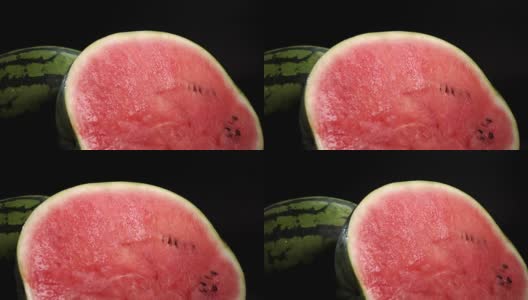 切片西瓜，红色果肉在黑色的背景高清在线视频素材下载