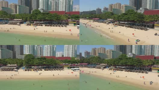 阳光明媚的三亚著名的大东海拥挤的海滩航拍全景4k中国海南高清在线视频素材下载