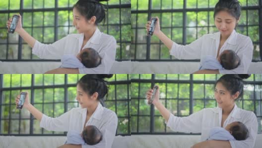 妈妈和宝宝用智能手机自拍，慢镜头高清在线视频素材下载