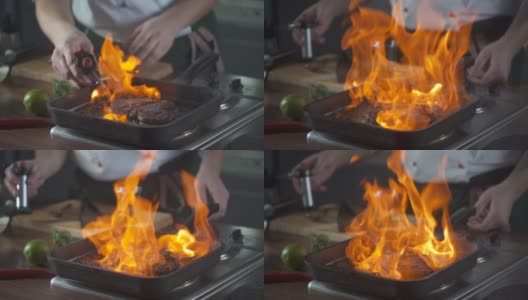 厨师在烤盘上制作火焰风格的牛排。油和酒精用明火燃烧。在烹饪食物。营养在美食厨房。做顿饭。准备吃的食物。美味的菜。高清在线视频素材下载