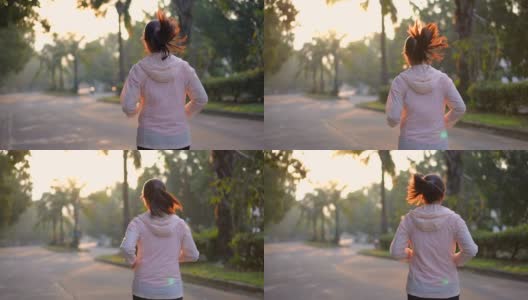 妇女早上在村公园跑步，锻炼和健康的概念高清在线视频素材下载