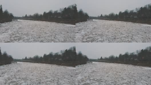 巨大的冰块漂流在拉脱维亚的食人河。空中龙拍摄雪城日。春天这条河上的交通堵塞。一大群移动的冰块高清在线视频素材下载