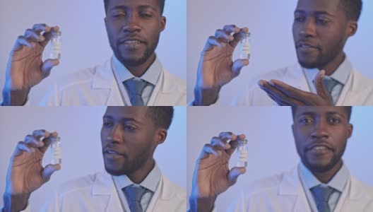 非洲裔美国医生手持Covid-19疫苗瓶高清在线视频素材下载