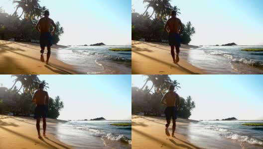 穿着蓝色短裤的人在潮湿的沙滩上奔跑，留下脚印高清在线视频素材下载