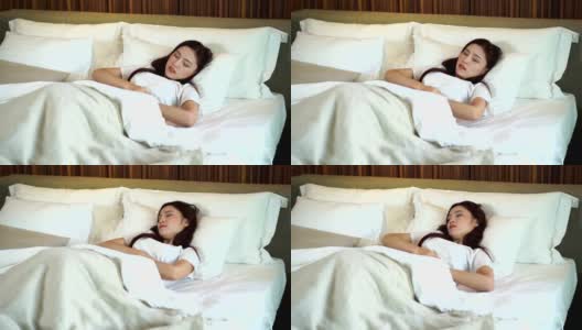 胃痛卧床妇女动作缓慢高清在线视频素材下载