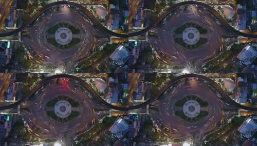 鸟瞰图巨大的环岛和交通灯在胜利纪念碑晚上在曼谷，泰国高清在线视频素材下载