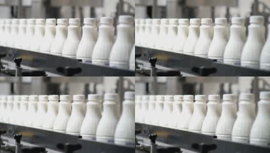 白色塑料奶瓶的连续镜头在生产线上分拣和前进的包装高清在线视频素材下载