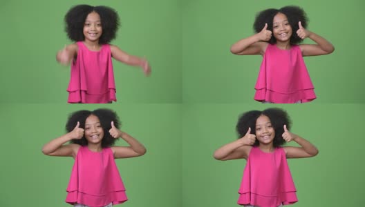年轻可爱的非洲女孩，有着非洲式的头发，竖起大拇指高清在线视频素材下载