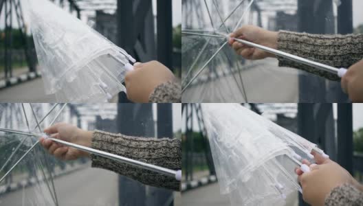 雨天里年轻女性手撑伞特写，慢镜头高清在线视频素材下载