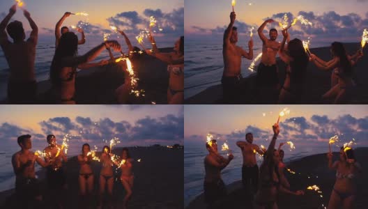 朋友们在海滩上玩烟花在日落高清在线视频素材下载