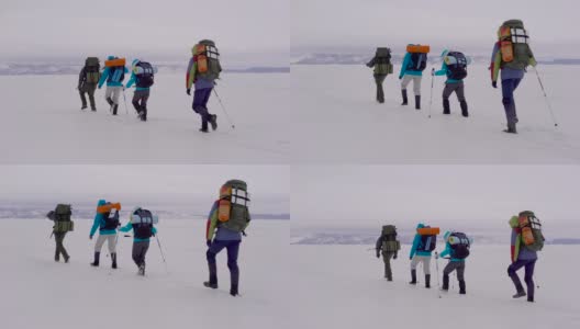 四个年轻人去雪域沙漠徒步旅行高清在线视频素材下载