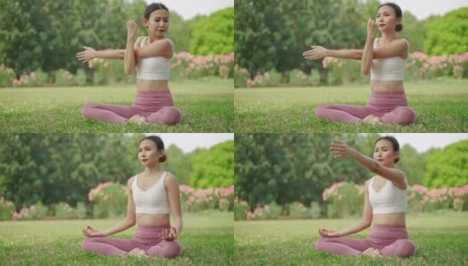 一位年轻的亚洲女子坐在花园里练瑜伽，她很放松，很享受锻炼。高清在线视频素材下载