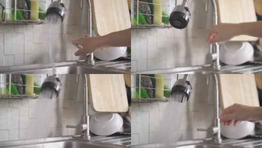 女人用手打开和关闭厨房水槽上的水龙头高清在线视频素材下载