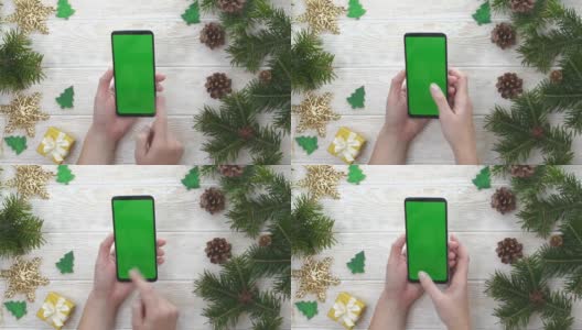 绿屏技术手机在圣诞装饰桌上俯视图平放，模拟空间文字复制，手人使用智能手机色度键，新年在线概念高清在线视频素材下载