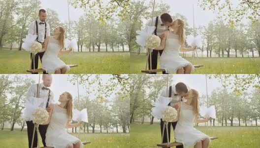 新娘在秋千上亲吻新郎高清在线视频素材下载
