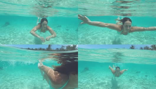 特写:快乐的女人穿着比基尼享受在美丽的绿松石海潜水。高清在线视频素材下载