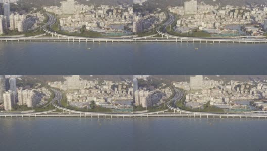 沿海城市的密集建筑和海上高速公路上的交通流量高清在线视频素材下载