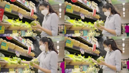 亚洲女孩戴着口罩保护她的脸在超市购物高清在线视频素材下载