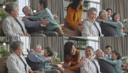 幸福的亚洲多代家庭，祖父母，孙子，拥抱，亲吻，一起爱，温柔，照顾，共度时光，三代人一起玩，坐在沙发上高清在线视频素材下载