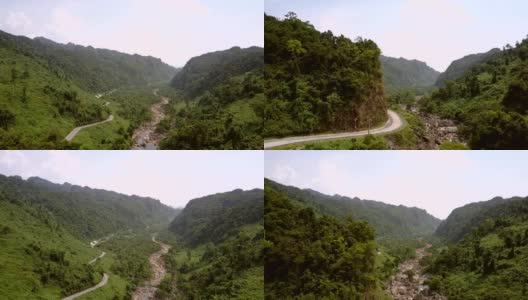 狭窄的柏油路沿着河边的山脚弯弯曲曲高清在线视频素材下载