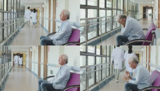 年长的亚洲人坐在医院走廊上，看起来悲伤和崩溃高清在线视频素材下载