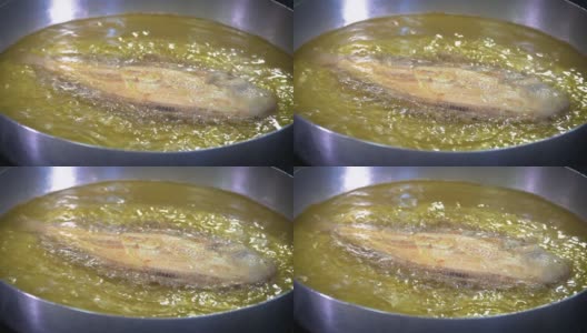 在大锅里煎鱼高清在线视频素材下载