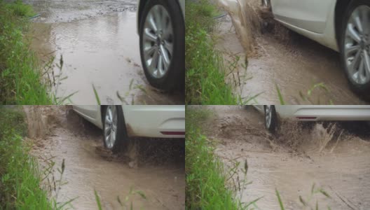 汽车穿过泥泞的水坑高清在线视频素材下载