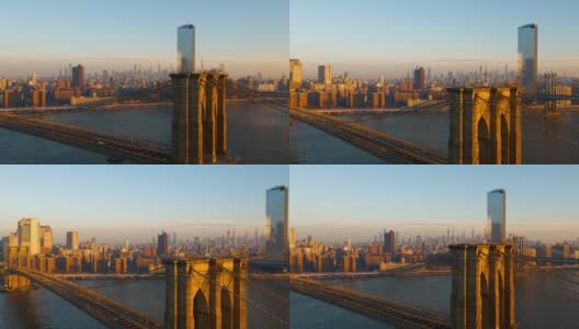 布鲁克林大桥鸟瞰图与遥远的曼哈顿地平线横跨东河和日出。无人机视频与全景轨道和上升的摄像机运动。高清在线视频素材下载