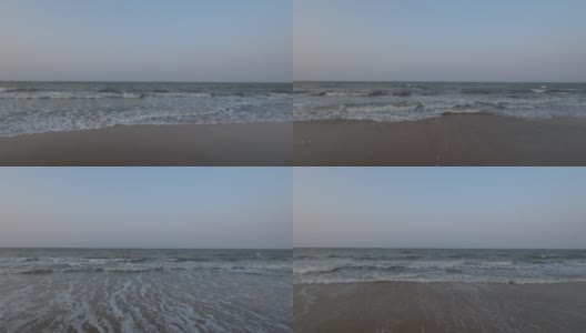 傍晚沙滩上的汹涌海浪的正面视图高清在线视频素材下载