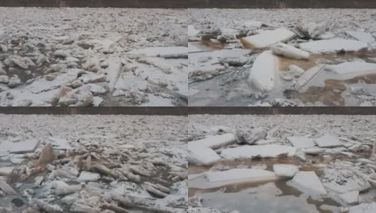 巨大的冰块漂流在拉脱维亚的食人河。空中龙拍摄雪城日。春天这条河上的交通堵塞。一大群移动的冰块高清在线视频素材下载