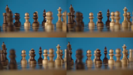国际象棋在蓝色背景上的特写。木质棋子。概念:棋盘游戏和智力活动高清在线视频素材下载