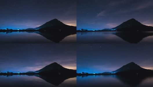 夜晚，星星的轨迹在山上和湖里移动。高清在线视频素材下载