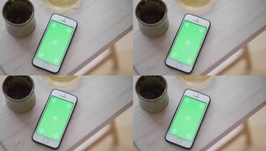 顶视图绿屏智能手机和咖啡滴高清在线视频素材下载