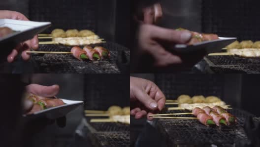 慢镜头小贩在夜市街头用钢烤架烹饪烤肉串。高清在线视频素材下载