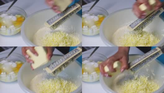 一位妇女在混合配料，准备做大理石蛋糕。用磨粉器把黄油磨成面团。高清在线视频素材下载