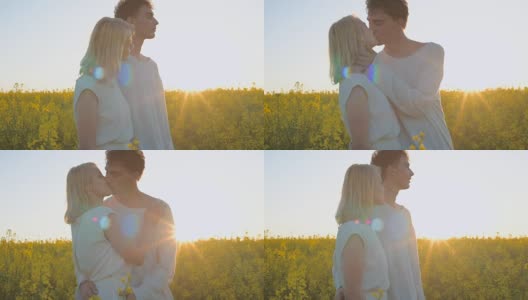 Happy young couple in yellow rape flowers field during sunset高清在线视频素材下载