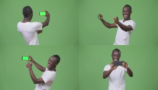 年轻的非洲男子用绿色背景的手机视频通话高清在线视频素材下载