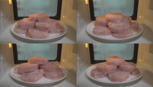 用微波炉解冻食物。用微波炉加热冷冻生鱼肉高清在线视频素材下载