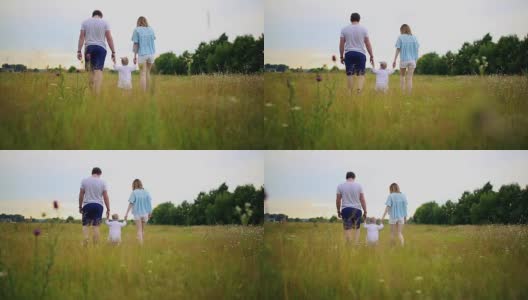 幸福的一家人一起在草地上散步，享受生活高清在线视频素材下载