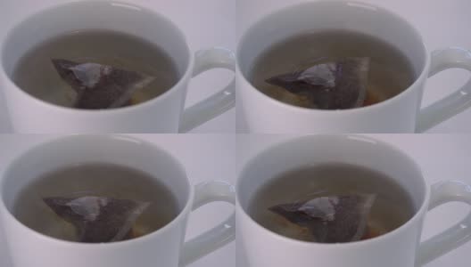 茶袋冲泡在一大杯水高清在线视频素材下载