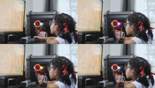 亚洲小女孩穿着泰国学生制服，用手写板画画，用电脑进行数字绘画高清在线视频素材下载