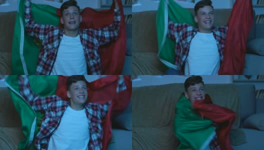 少年拿着葡萄牙国旗在家看比赛，支持国家队高清在线视频素材下载