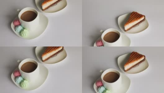 五颜六色的蛋白糖霜和一杯白色背景的咖啡高清在线视频素材下载