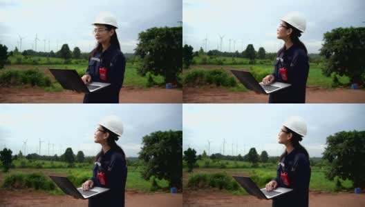 穿着制服的女维护工程师在风力涡轮机农场工作高清在线视频素材下载